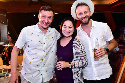 Colleagues smiling for a photo during a company social gathering.